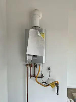 Newly installed tankless water heater with the install tag still on.