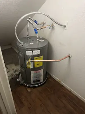 Tank water heater in a closet with new water supply lines.