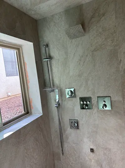 Modern shower valve and hand shower installed.