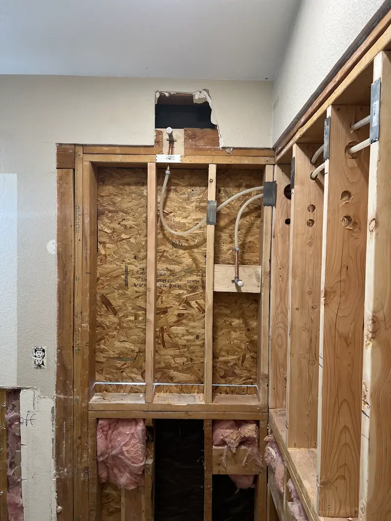 New PEX water lines run through opened walls during a repipe.