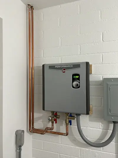 Rheem electric tankless water heater installed with copper piping.