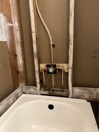 New shower valve rough-in above a tub.