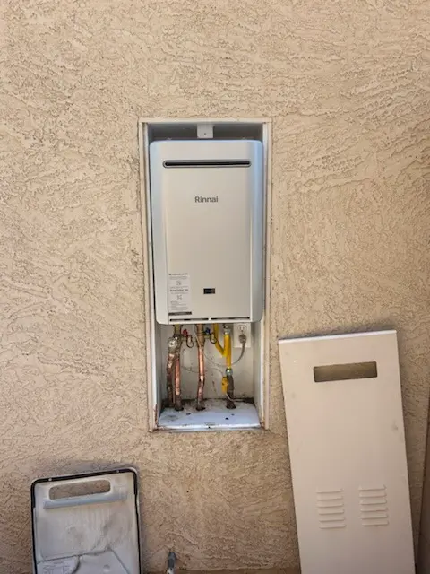 Rinnai tankless water heater installed in an exterior recess box.