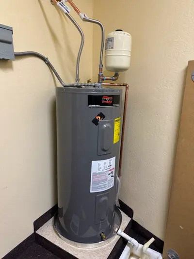 Electric tank water heater installed with a thermal expansion tank.